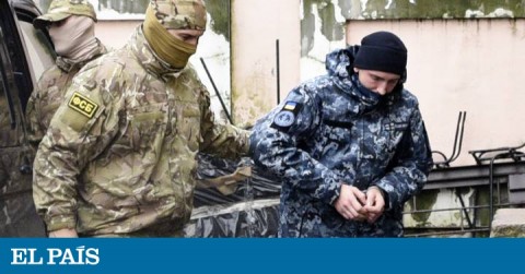 Ukrainian marine being escorted by a Russian official to a court in Simferopol.