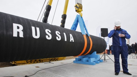 A Russian construction worker speaks on a mobile phone in Portovaya Bay some 170 kms northwest from St. Petersburg, Russia, during a ceremony marking the start of Nord Stream pipeline construction, April 9, 2010. Photo: Reuters file photo