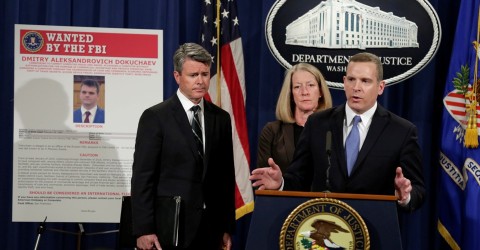 Paul Abbate, the then–FBI assistant director of the Criminal, Cyber, Response, and Services Branch, speaks next to a poster of a suspected Russian hacker in 2017 Photo: Yuri Gripas / Reuters