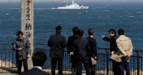 A Japanese coast guard vessel sails off Cape Nosappu on Japan's Hokkaido island, with part of the islands known as the Northern Territories in Japan and the Southern Kurils in Russia visible in the background. Photo: Issei Kato / Reuters file