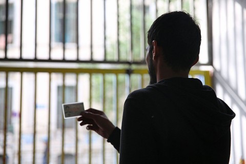 Syrian national Fadi Jassem holds his Syrian ID card in Athens. He says he was ‘pushed back’ into Turkey from Greece while looking for a sibling who had gone missing in the border area. Photo: Dominique Soguel