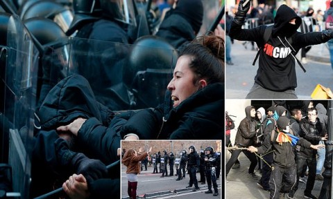 A woman scuffles with members of the Catalan regional police force during the protests sparked by a cabinet meeting held by PM Pedro Sanchez in Barcelona. Photo: AFP / Getty Images