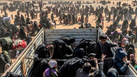 Women and children ride in a truck as they prepare to leave Baghouz, the last IS –held village in Syria. Photo: B. Kilic / AFP / Getty Images