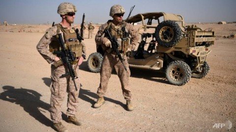 US Marines keep watch as unseen Afghan National Army soldiers participate in an IED (improvised explosive device) training exercise.