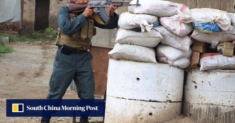 An Afghan security force member takes position during a fighting with Taliban in Kunduz province, Afghanistan, on Saturday.