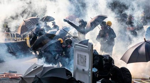 Tear gas fired at Hong Kong new year's mass march as protesters vow to keep fighting