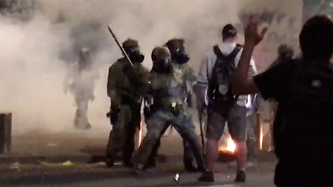 A man is struck by a police officer during a protest against racial inequality in Portland, U.S., July 18, 2020, in this still image obtained from a social media video