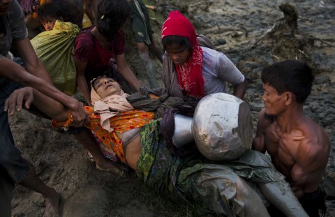 A Rohingya child sleeps inside a basket in which he was carried as a group of Rohingya fled Myanmar into Bangladesh