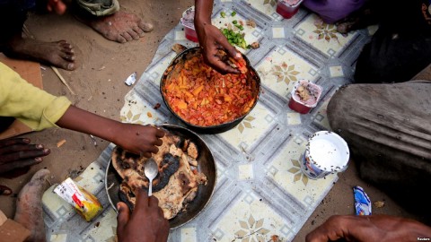 Members of the Ruzaiq family eat a meal outside their hut, next to a garbage dump where they collect recyclables and food near the Red Sea port city of Hodeidah, Yemen, Jan. 9, 2018.