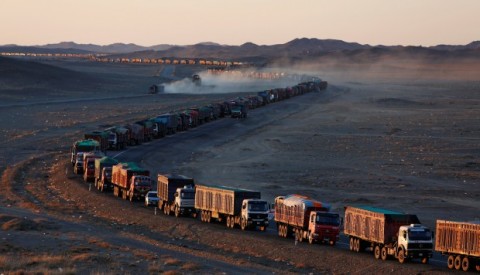 Thousands of heavy-duty trucks loaded with coal make their way along the sole road through the Gobi desert in Mongolia to the Chinese border. Photo: Reuters