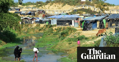 Rohingya refugees cross a canal next to a settlement near the area between Myanmar and Bangladesh in Tombru. Photograph: Munir Uz Zaman/AFP/Getty Images