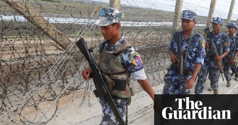 Myanmar border guard police officers patrol along a beach near a makeshift camp at the Myanmar-Bangladesh border. Photo: Hein Htet/EPA