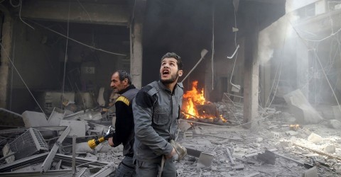 Civil defense members with a firehose react at a damaged site after an airstrike in the besieged town of Douma, eastern Ghouta, near Damascus, Syria, on February 9, 2018. Photo: Bassam Khabieh / Reuters