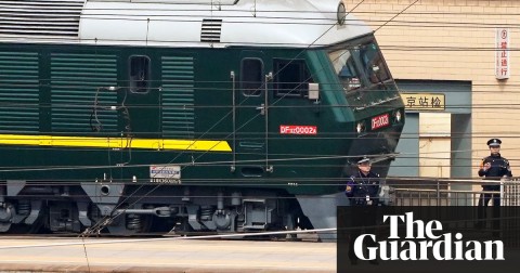 Police officers keep watch next to train at Beijing railway station. Photograph: Jason Lee/Reuters