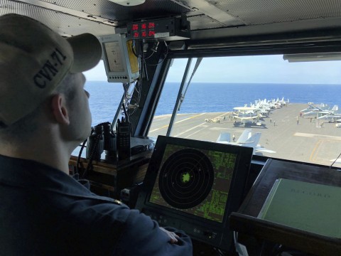 A US Navy crewman monitors activity on the deck of the aircraft carrier Theodore Roosevelt, Tuesday, April 10, 2018, in international waters of the South China Sea.  Photo: Jim Gomez/AP