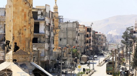 Civilians walk in the formerly rebel-held Syrian town of Douma, on the outskirts of Damascus, on Tuesday. Photo: AFP/Getty Images