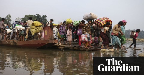 Displaced residents of Kachin state cross Malikha river to escape fighting. Photograph: Zau Ring Hpara/AFP/Getty Images