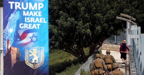 Military personnel patrol next to a sign welcoming the move of the U.S. embassy to Jerusalem. Photo: Ronen Zvulun / Reuters