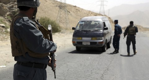 Afghan police officers search a vehicle on the Ghazni highway, west of the nation's capital, Kabul, earlier this year. Photo: Rahmat Gul/AP