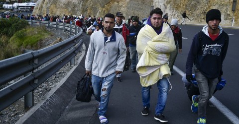 Venezuelans heading to Peru walk along the Pan-American Highway in Tulcan, Ecuador, after crossing from Colombia, on August 21, 2018. Photo: Luis Robayo / AFP / Getty 