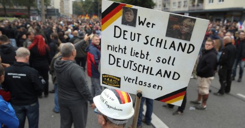 A protester holds up a sign reading 