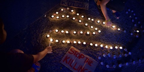 Protesters light candles and shout slogans as they march on the street on September 8, 2017 in Quezon City, Philippines. Photo: Jes Aznar/Getty Images