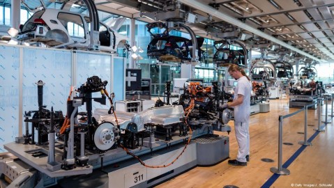 A technician works on a partly-assembled E-car at an automotive plant in Dresden. Photo: J. Schlueter / Getty Images