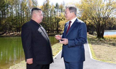 South Korean President Moon Jae-in and North Korean leader Kim Jong-un raise their hands after watching the mass games performance last month. Photo: AP